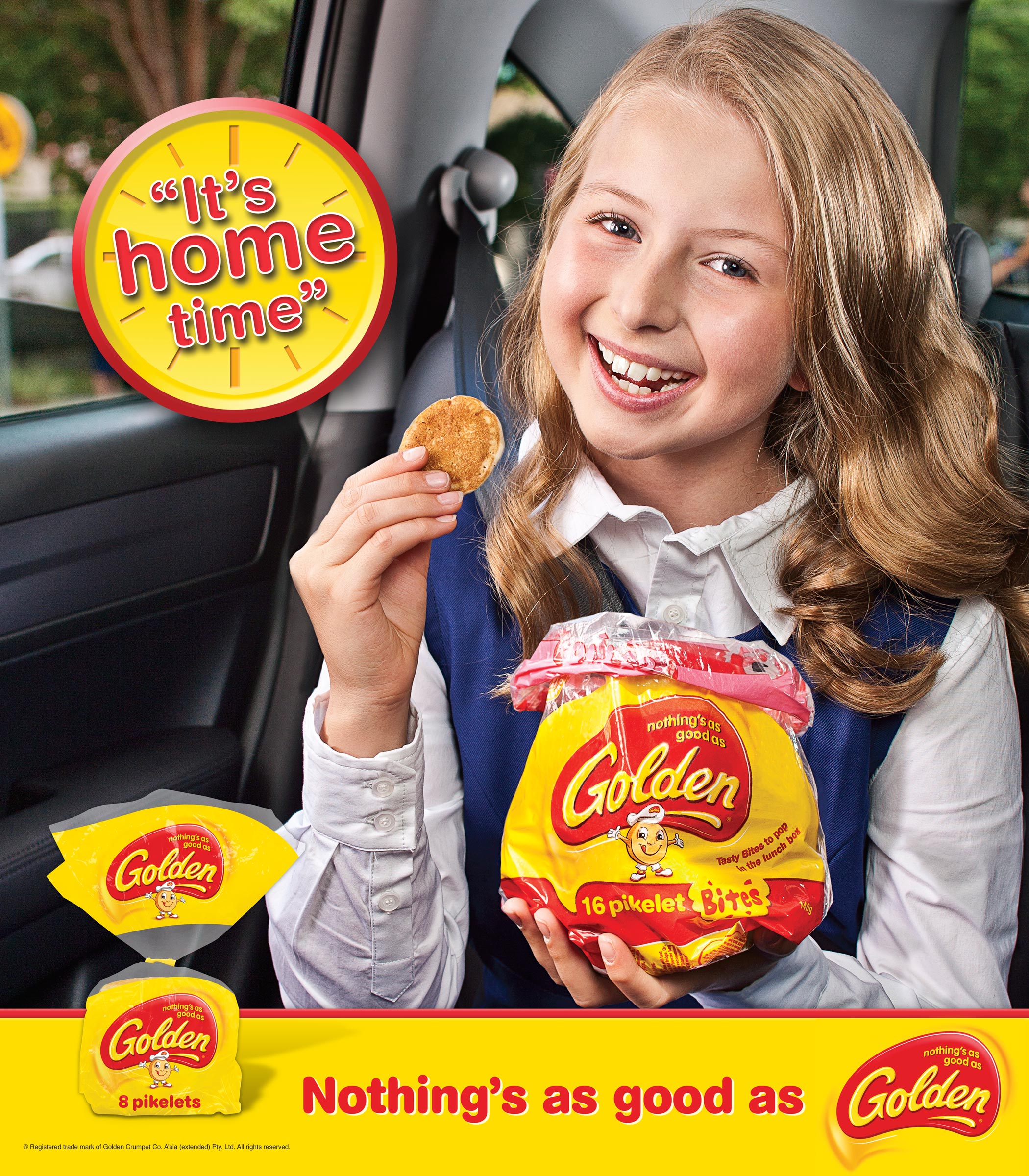 Advertising food product photography of young happy schoolgirl eating Golden pikelets in backseat of car