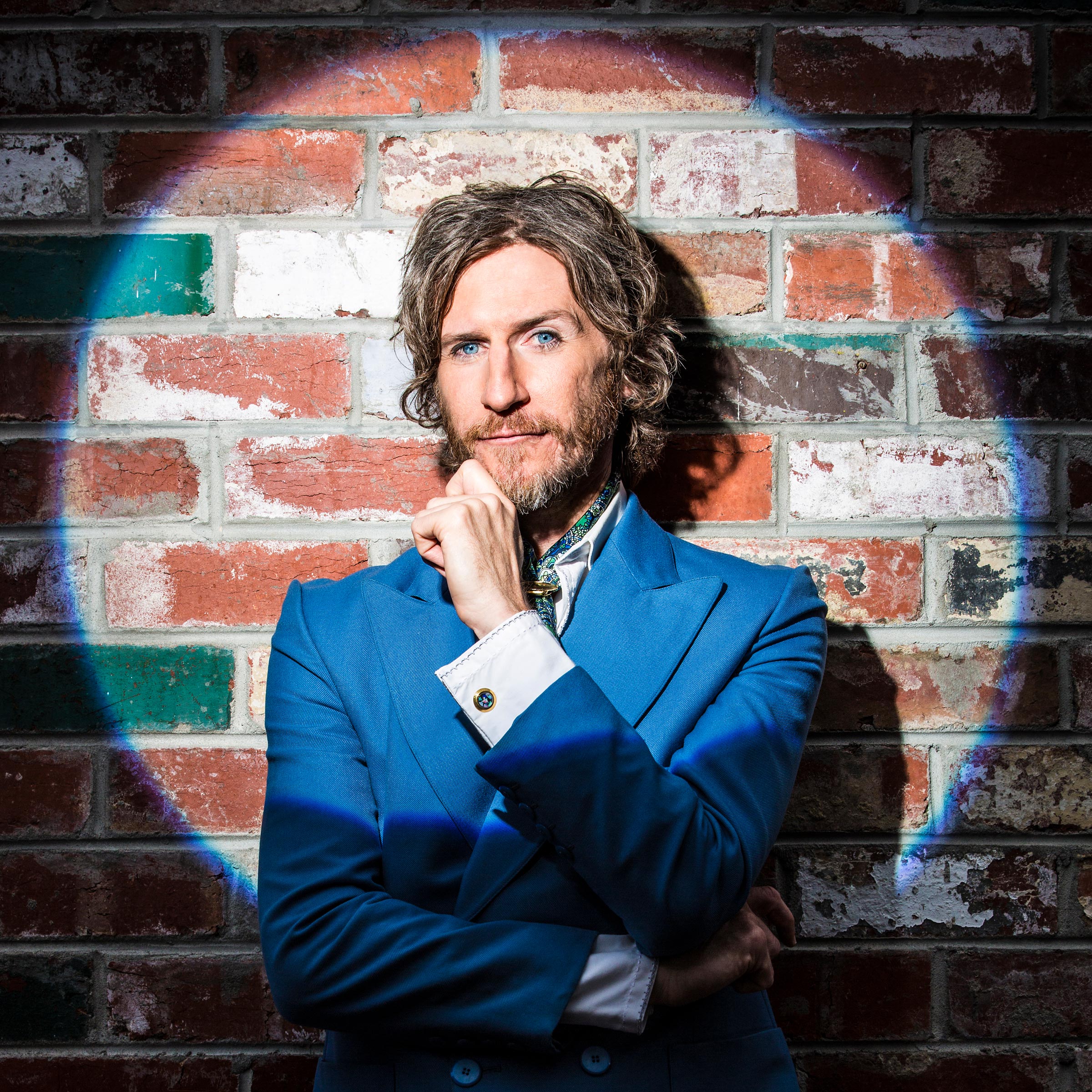 Advertising Foxtel TV commercial photography of Tim Rogers in spotlight leaning against brick wall