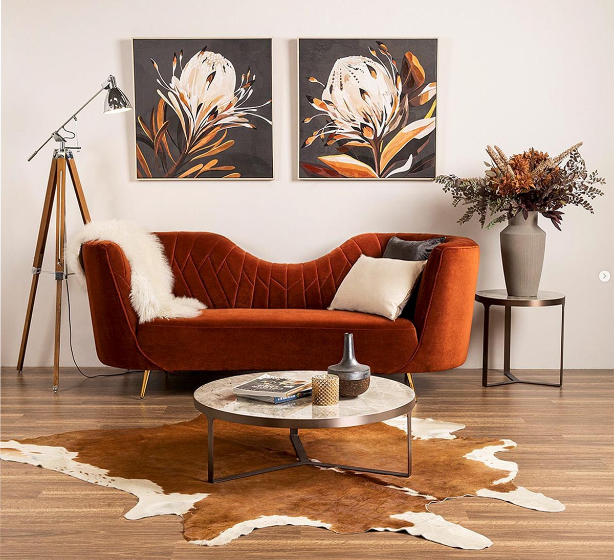 Product furniture photography of orange eclectic couch cow hide rug