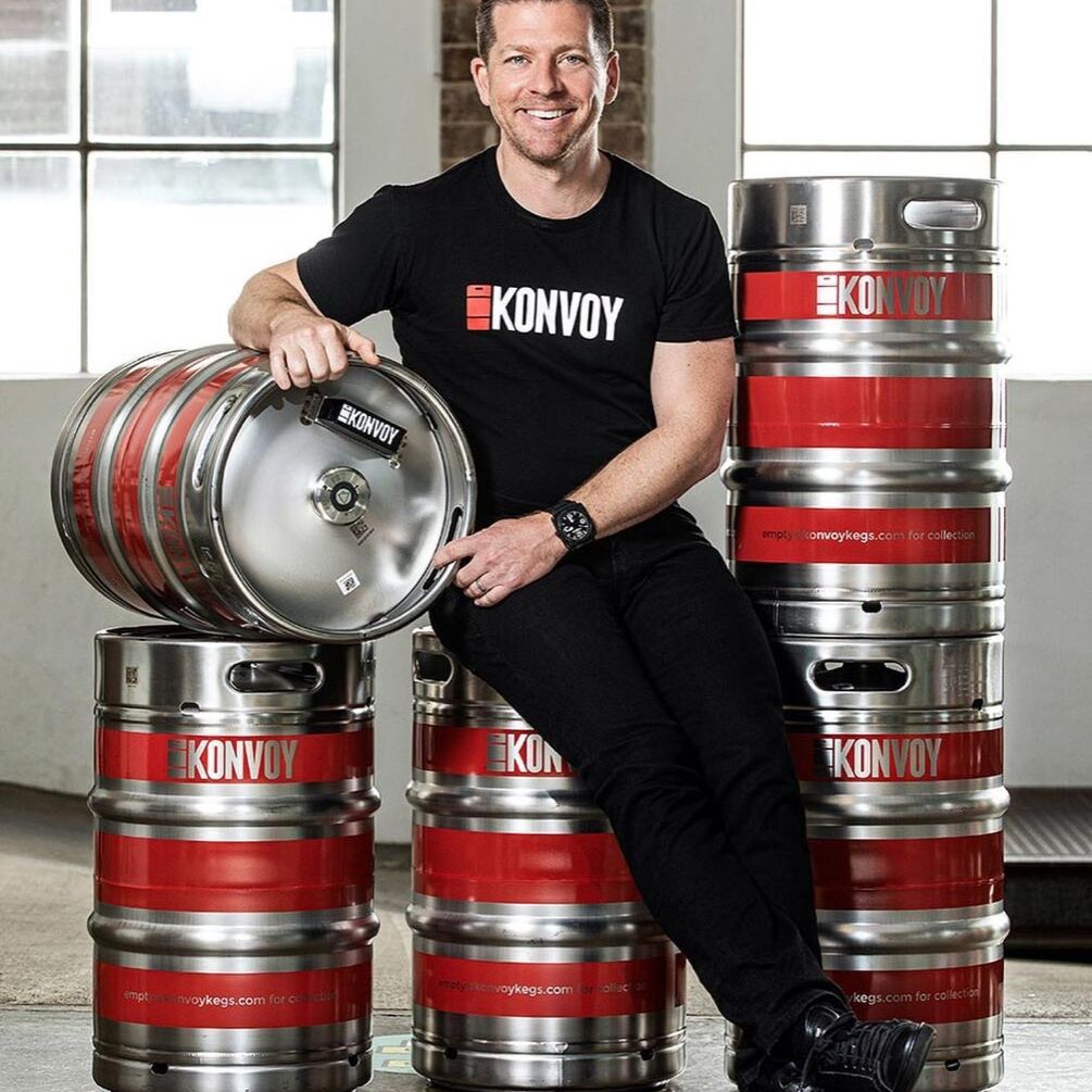 Editorial portrait photography Managing Director & Founder of KPNVOYAdam Trippe-Smith sitting on beer kegs
