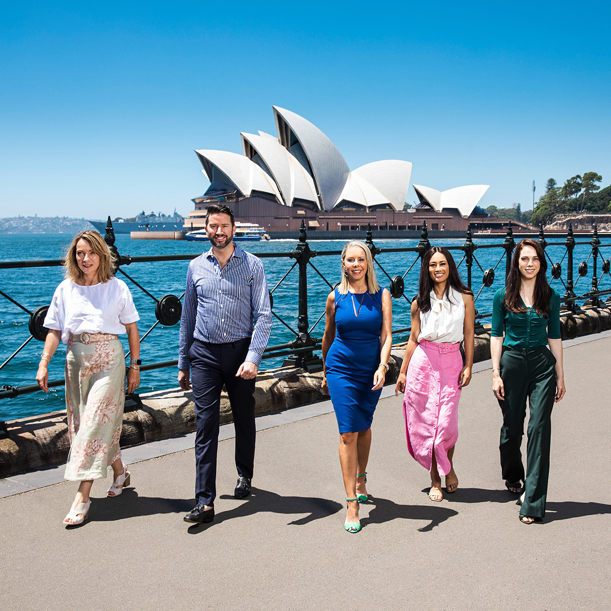 Location corporate group photography of 4 female 1 male walking with Sydney Opera House in background